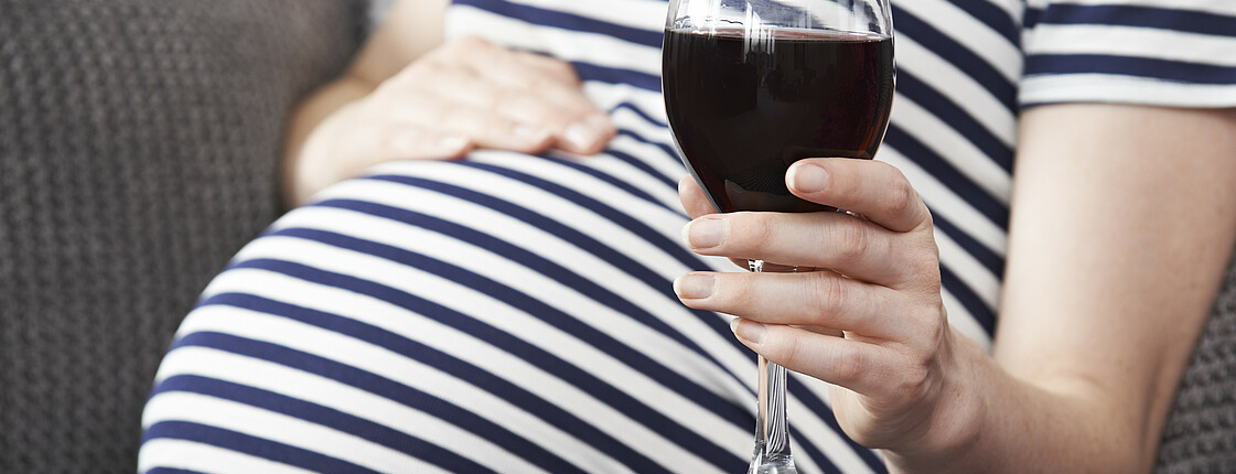 Close Up Of Pregnant Woman Drinking Red Wine